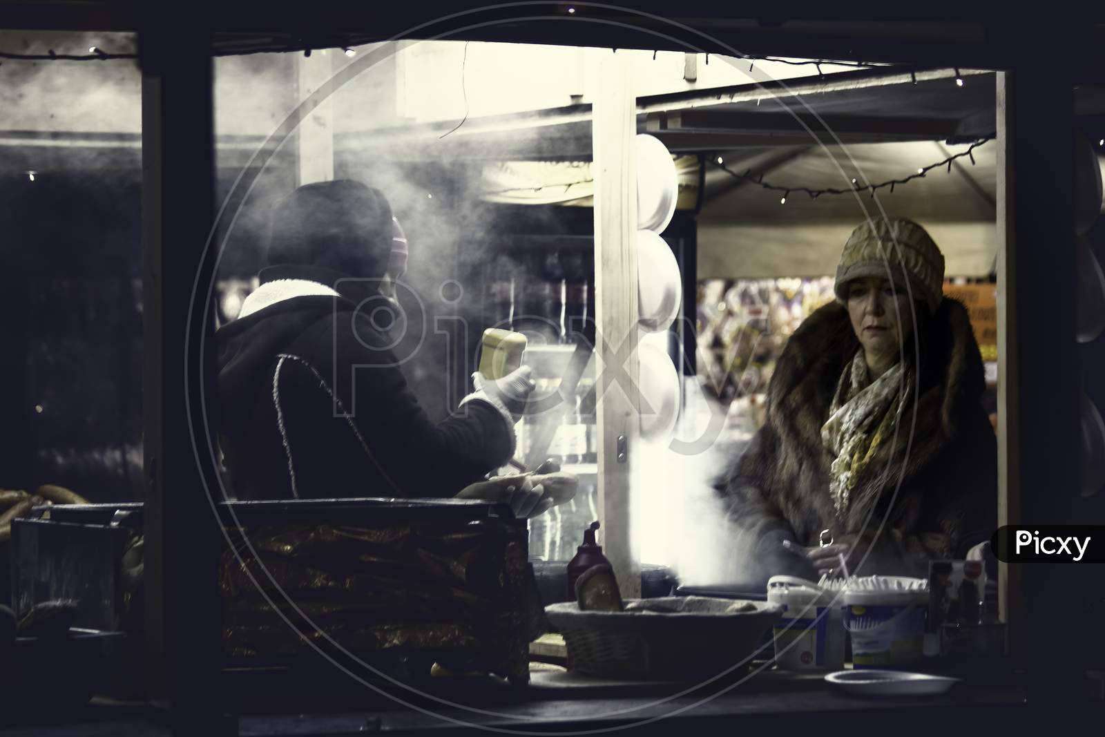 Krakow, Poland - December 08, 2014: Street Photography In Which Sellers Are Preparing Sausages For Tourists