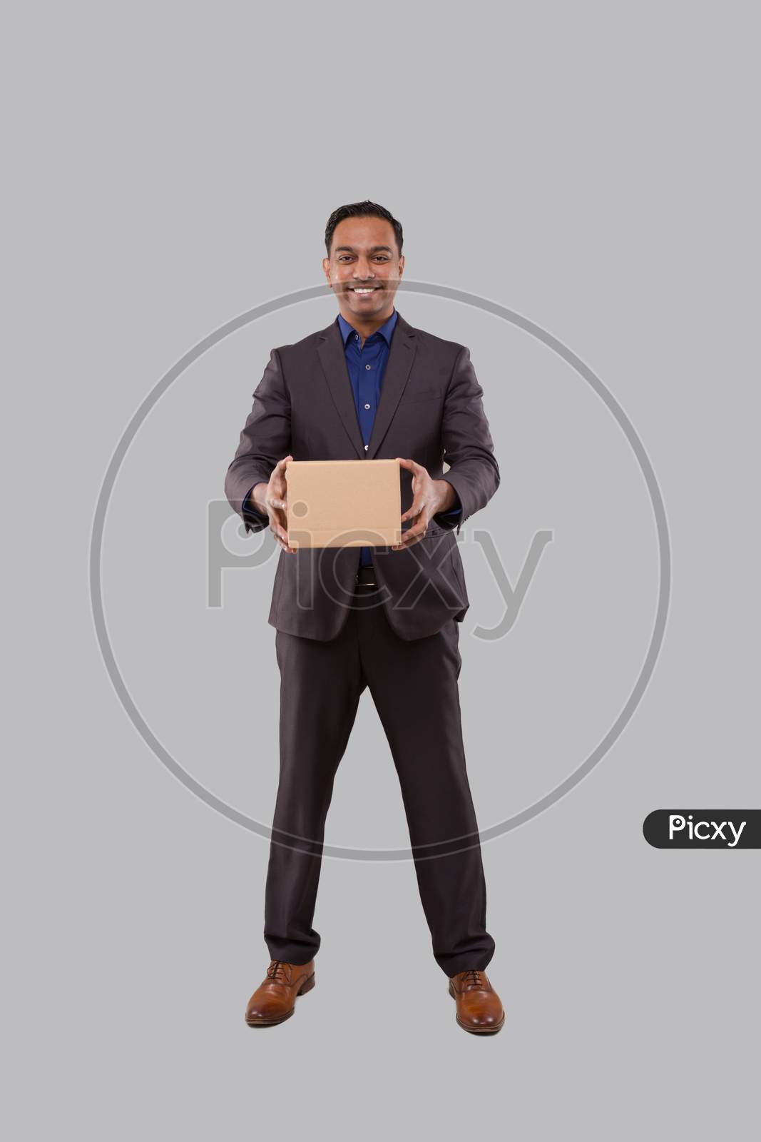 Businessman Holding Carton Box In Hands. Indian Business Man With Parcel In Hands.