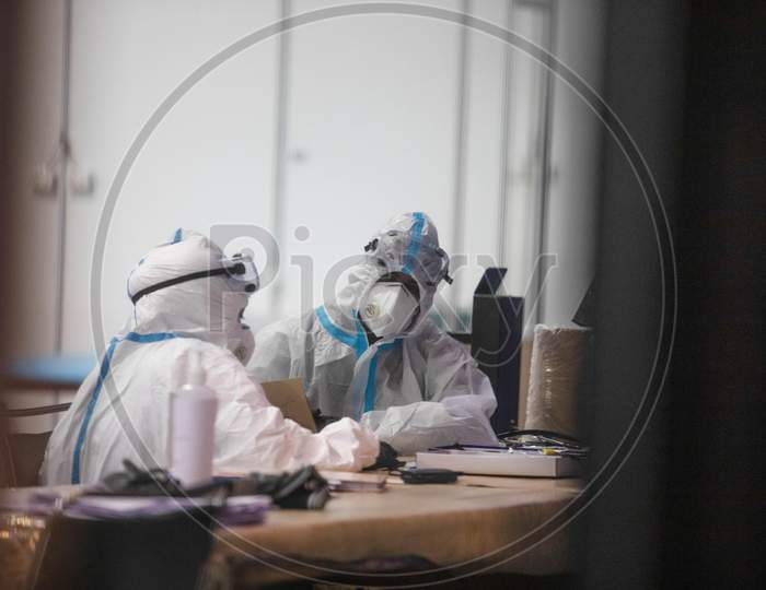 Two health workers wearing PPE suit work the Common Wealth Games stadium which has been converted into a Coronavirus Care Centre in New Delhi on July 17, 2020