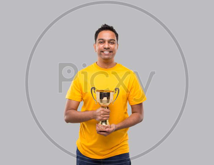 Indian Man Holding Trophy In Hands Isolated Smilling