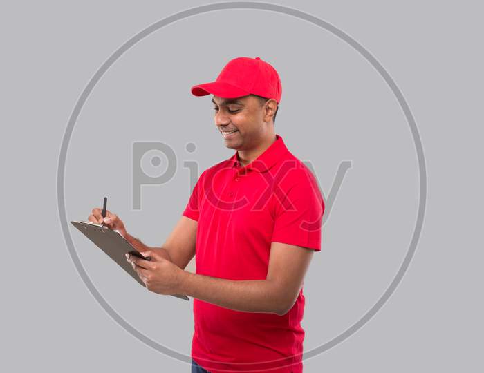 Delivery Man Writing In Clipboard. Indian Delivery Boy Clipboard
