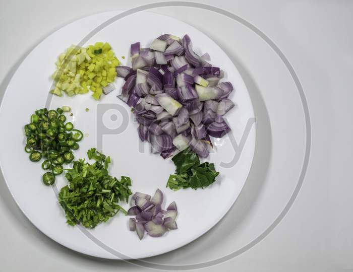 Chopped Mix Vegetables In A White Plate, Onion, Garlic, Ginger, Chilli, Coriander,