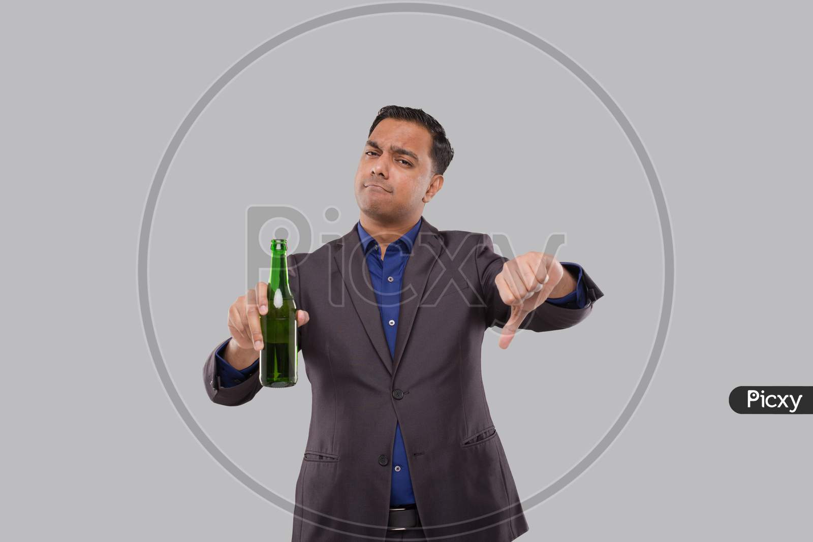 Businessman Holding Beer Bottle Showing Thumb Down. Indian Business Man With Beer Bottle In Hand.