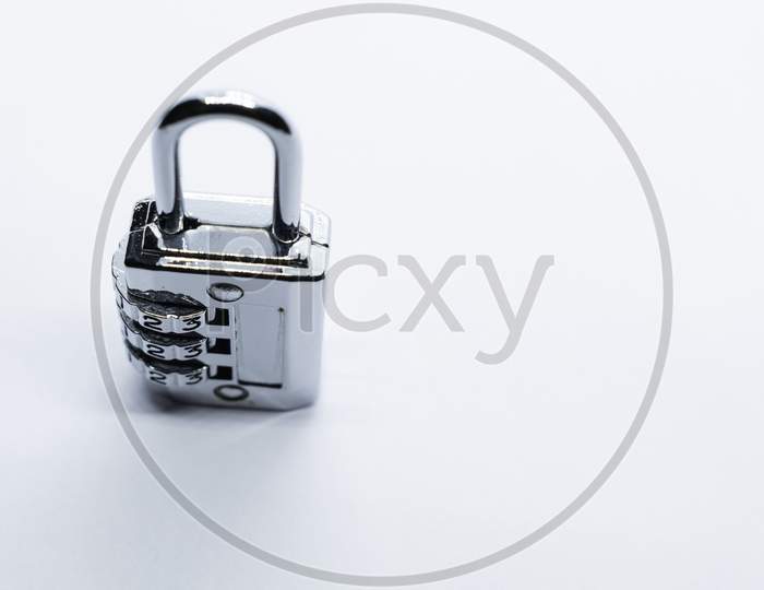 A Lock And Key On A Plain White Background. Selective Focus, Selective Focus On Subject, Background Blur