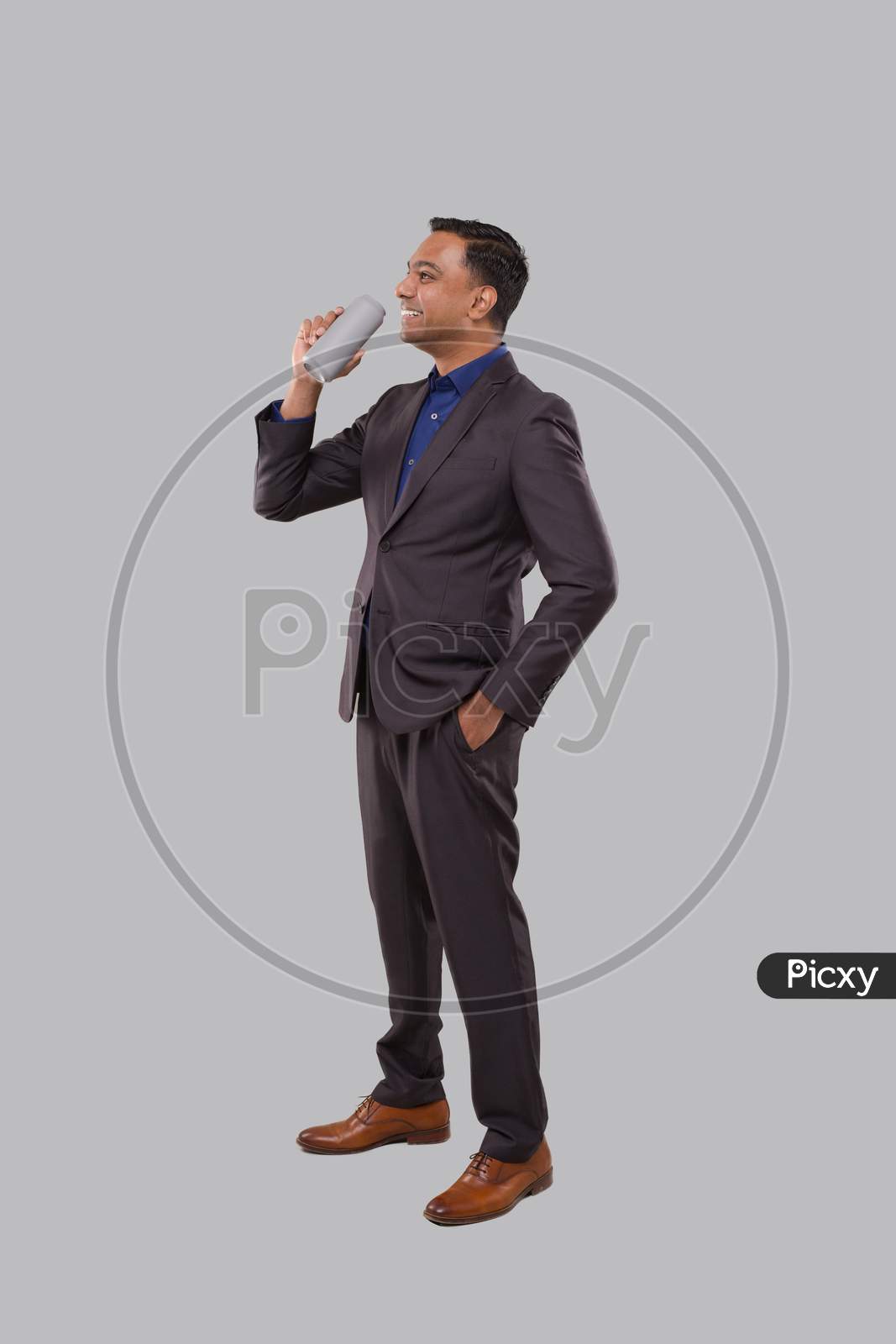 Businessman Drinking Beer From Tin Can. Indian Businessman Standing Full Length.