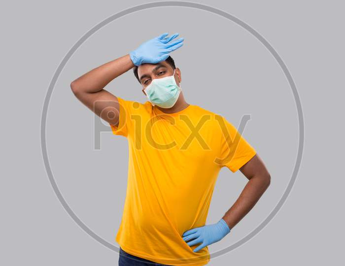 Indian Man Tired Sign Wearing Medical Mask And Gloves. Man Wiping Sweat Isolated