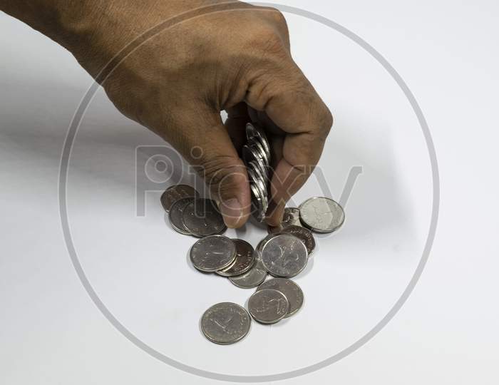 A Man Hand Taking Uae Currency Coins With White Background, Fils,
