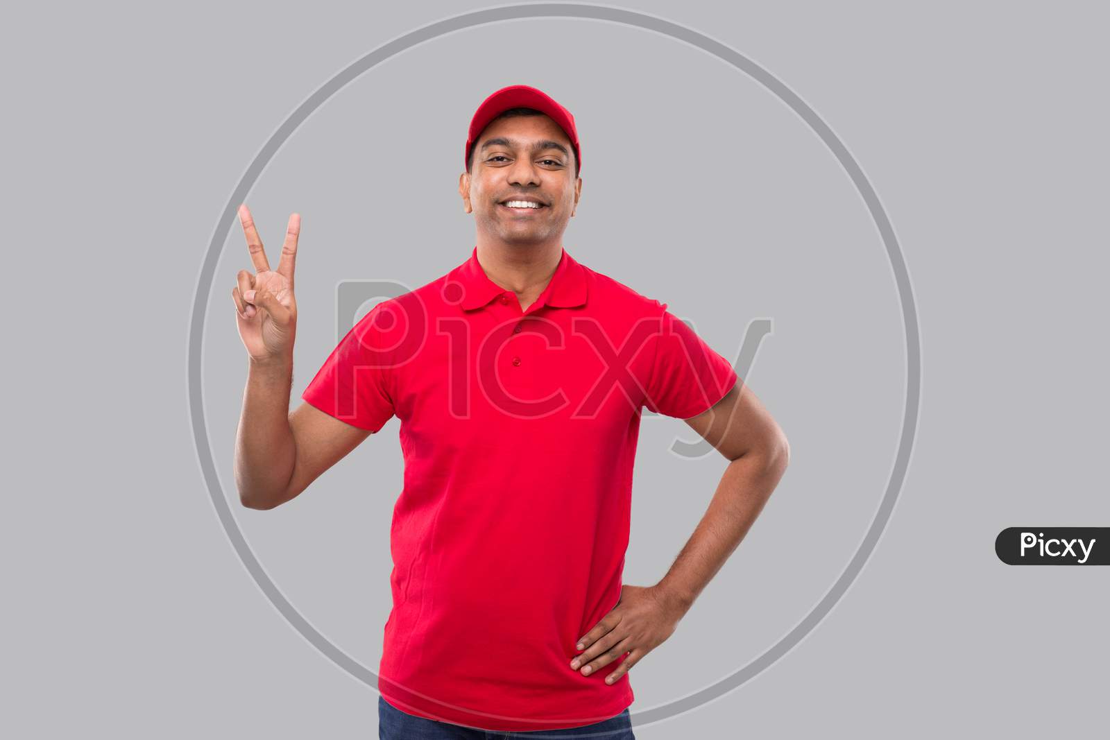 Delivery Man Showing Peace Sign Isolated. Indian Delivery Boy Smilling Peace
