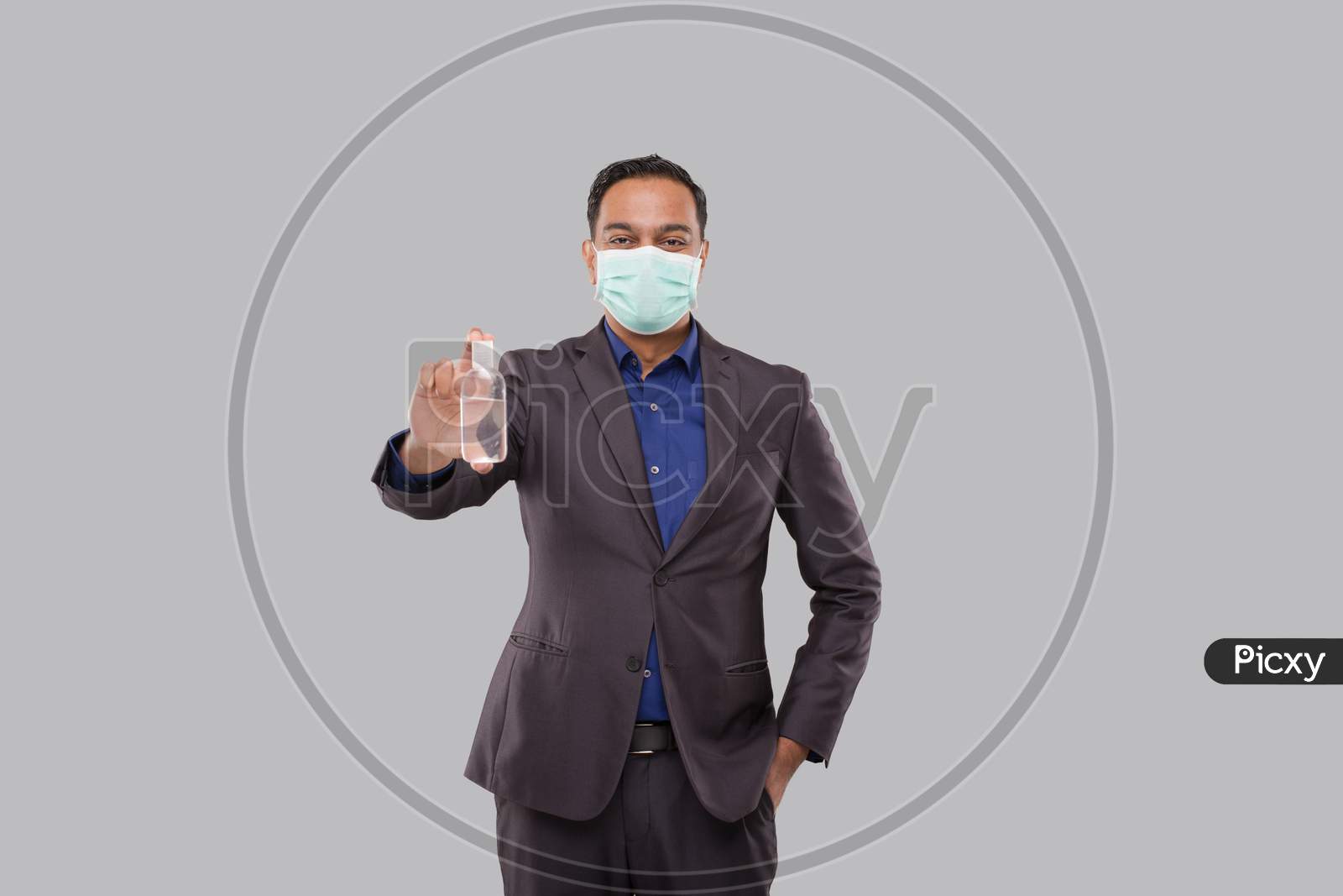 Businessman Showing Hands Sanitizer Wearing Medical Mask. Indian Business Man Holding Hand Antiseptic