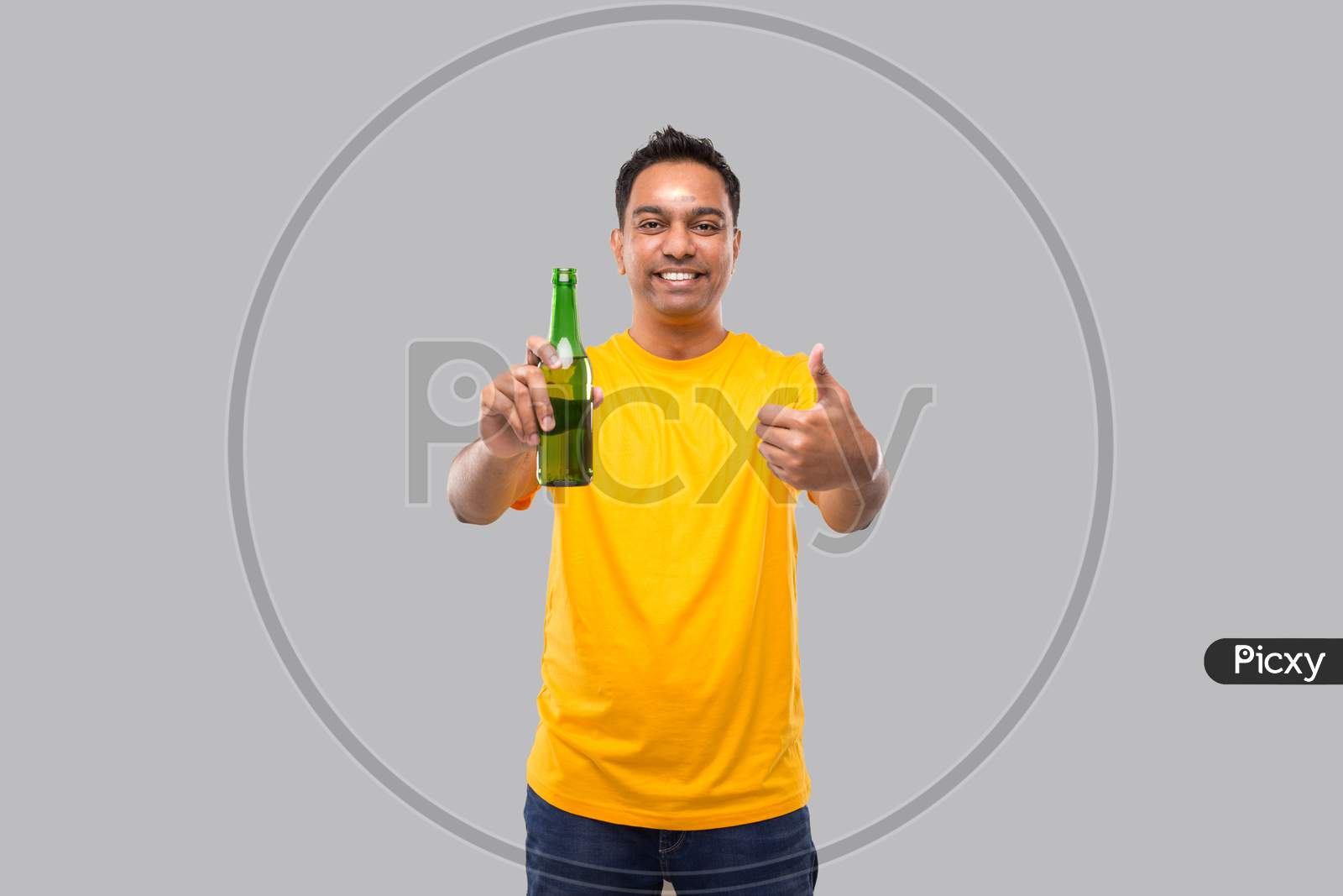 Indian Man Holding At Beer From Beer Bottle Showing Thumb Up Isolated.