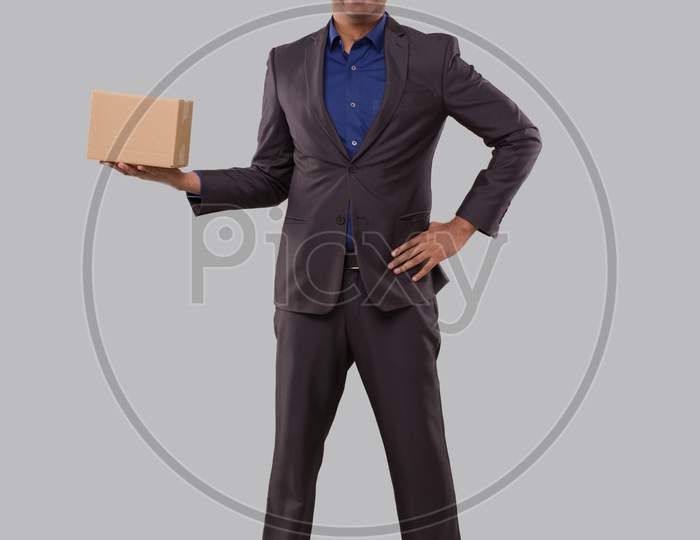 Businessman Holding Carton Box In Hands. Indian Business Man With Parcel In Hands.