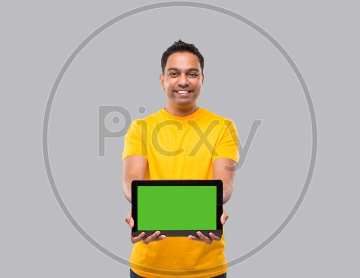 Indian Man Showing Tablet. Indian Boy With Tablet In Hands. Home Delivery, Technical Delivery
