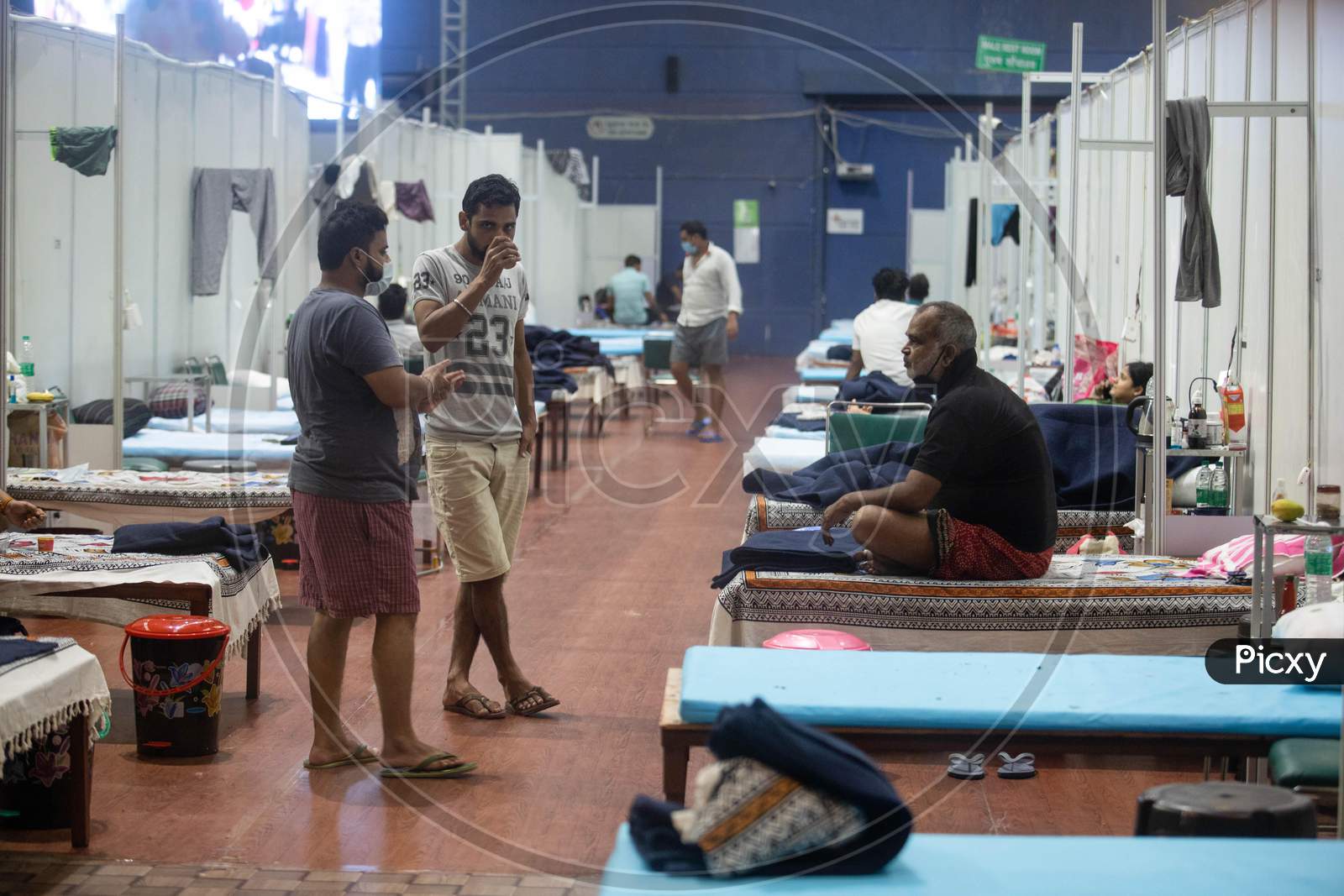 Patients tested positive for Coronavirus interact with each other while they are quarantined at Commonwealth Games Stadium which has been converted into a Coronavirus Care Centre in New Delhi on July 17, 2020