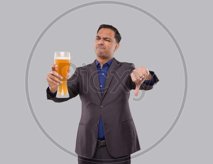 Businessman Holding Beer Glass Showing Thumb Down. Indian Business Man With Beer In Hand