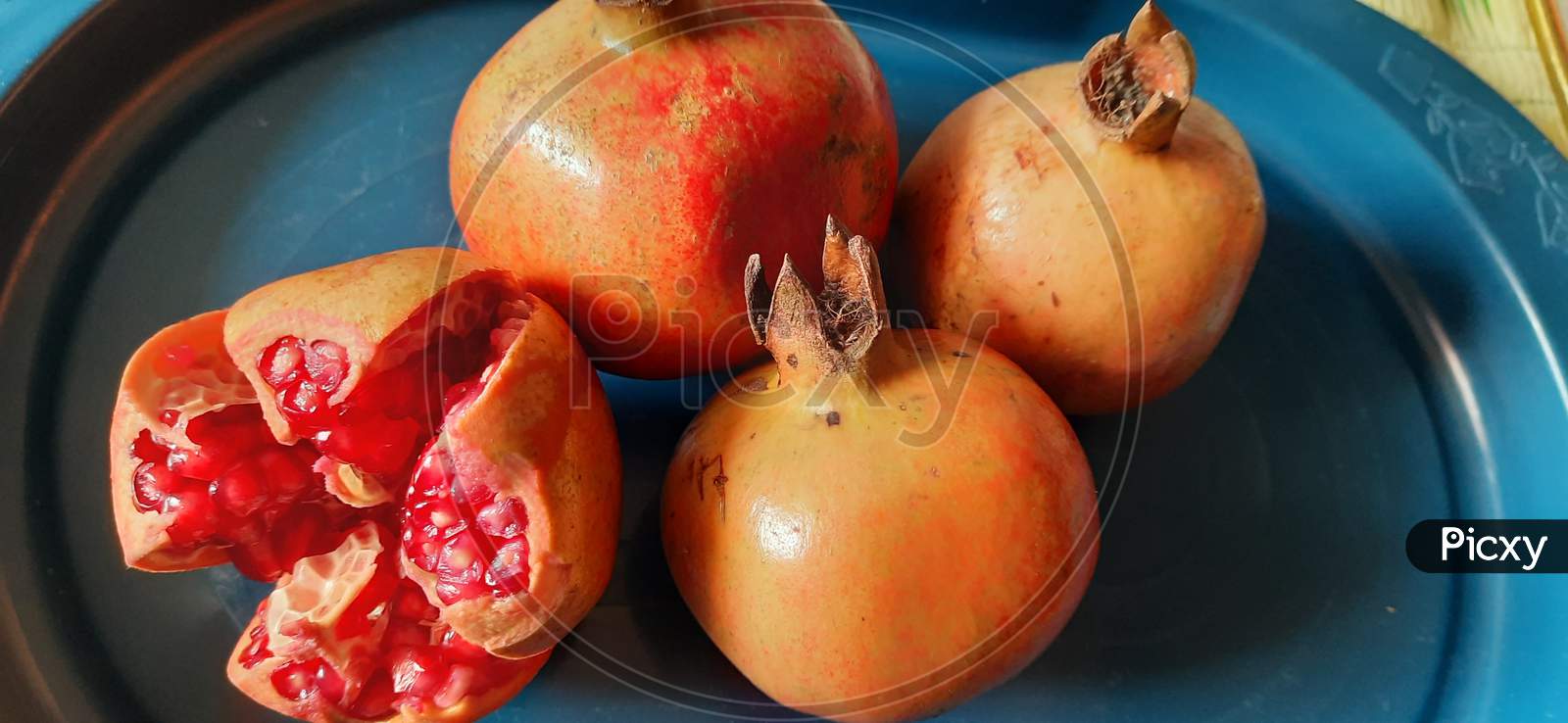 fresh organic pomegranate  red fruits closeup