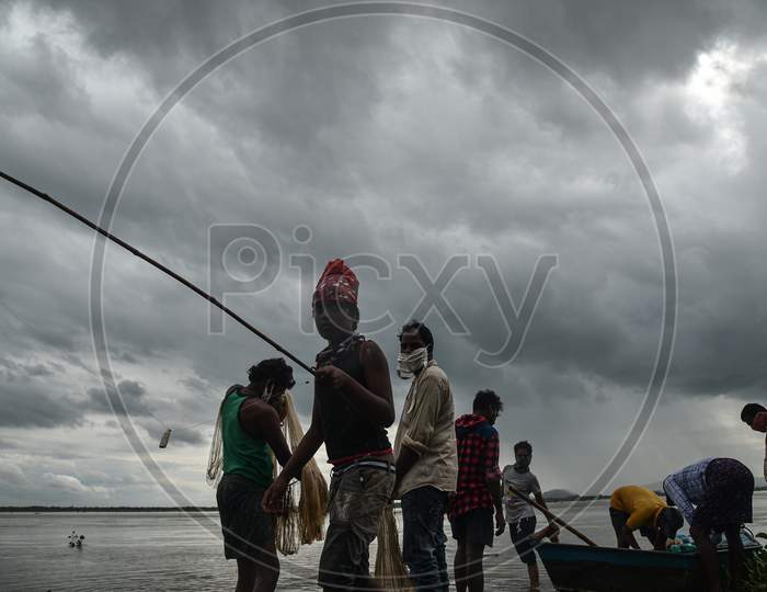 Fishermen prepare to catch fish in the swollen Krishna river following the release of surplus water from the Prakasam Barrage in Vijayawada.