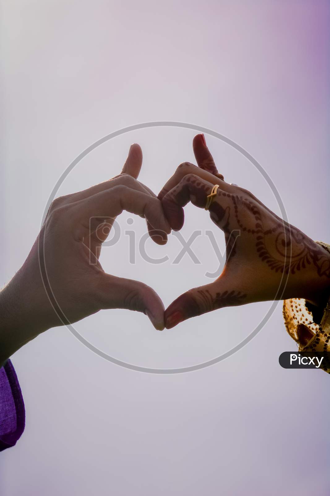 A Man And Woman Posing hands Like Heart Shape.