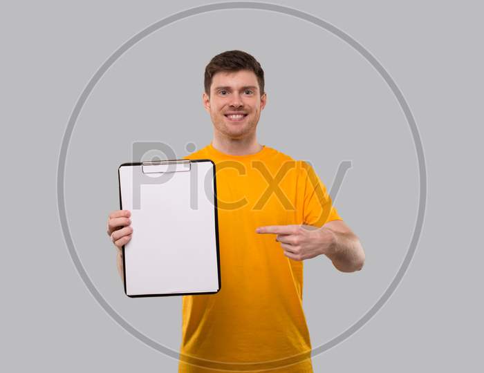 Man Pointing In Clipboard. Blank Clipboard In Hands