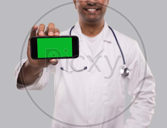 Doctor Showing Phone Horizontal Isolated. Indian Man Doctor Technology Medicine At Home. Phone Green Screen Close Up