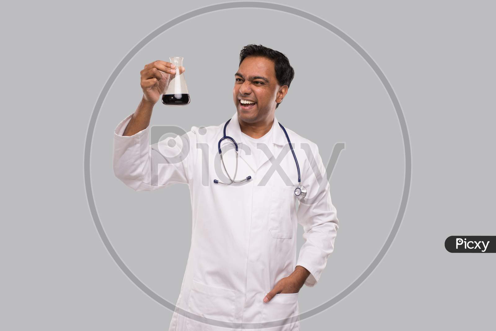Male Doctor Excited Checking Blood Analysis With Good Idea. Indian Man Doctor Examing Blood Tube Isolated. Medical, Science, Healthy Life Concept