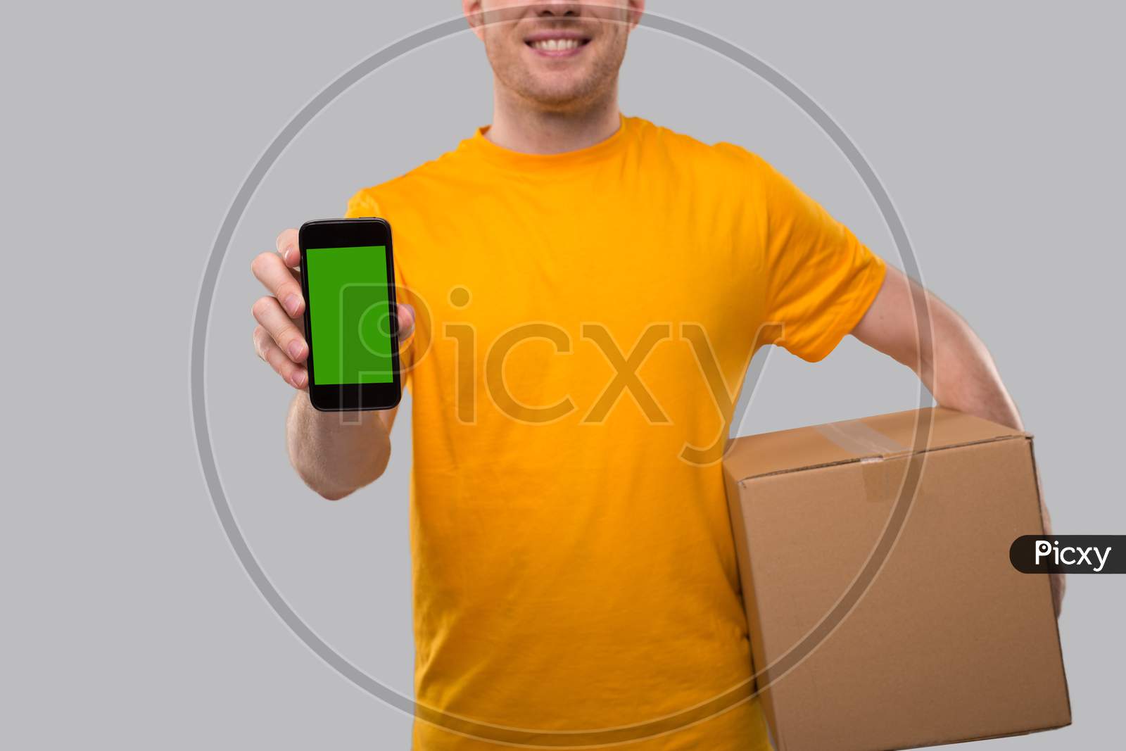 Delivery Man Showing Phone Holding Box. Phone Green Screen Close Up. Delivery Boy Smiling.