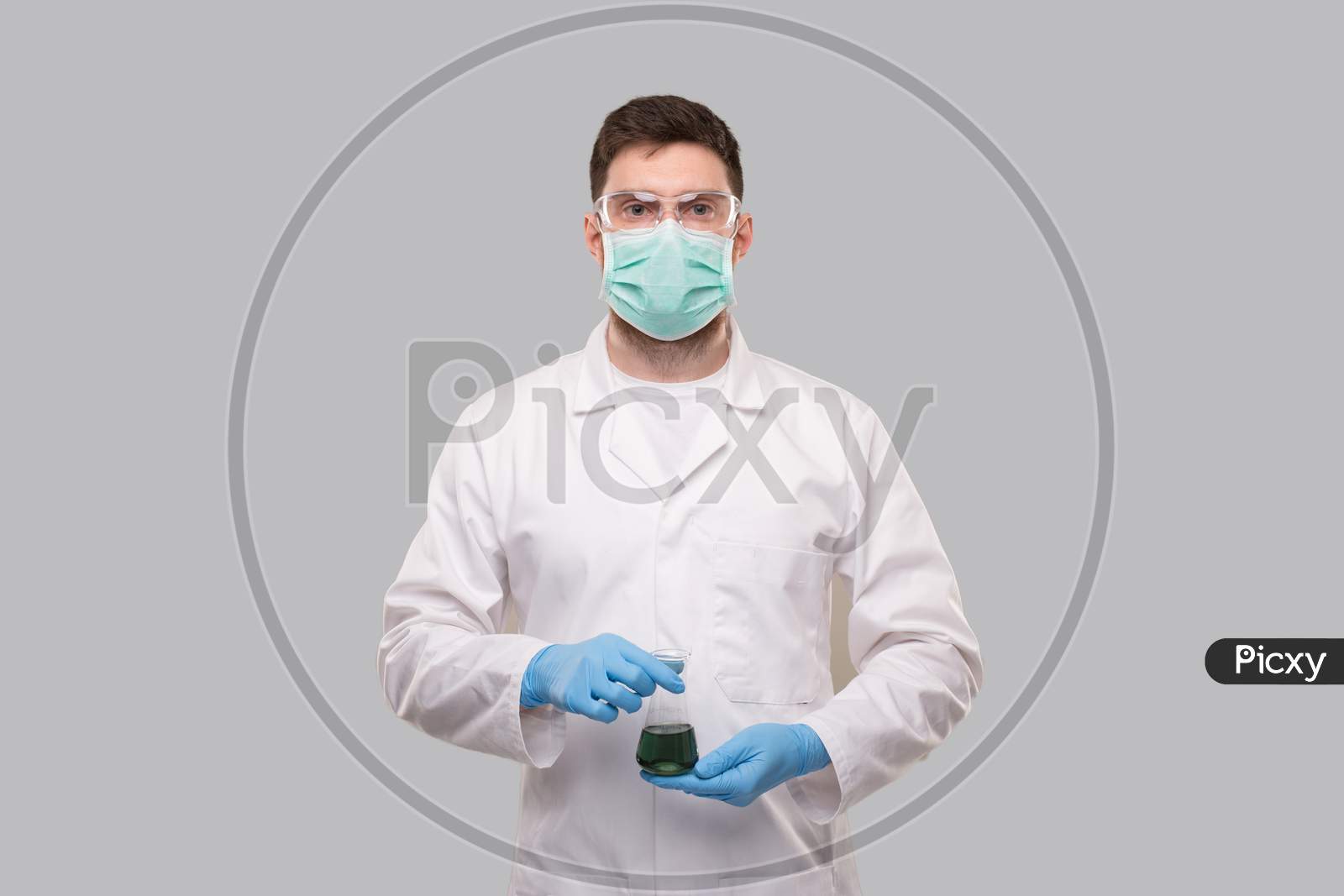 Male Doctor Wearing Medical Mask And Gloves Showing Flask With Colorfull Liquid. Science, Medical, Virus Concept