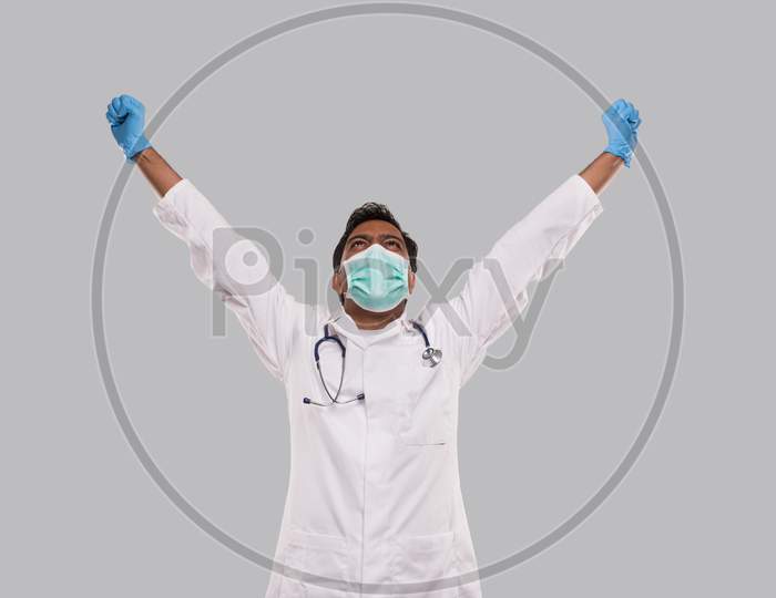 Doctor Excited Hands Up Celebrating Success Wearing Medical Mask And Gloves Isolated. Indian Man Doctor Happy