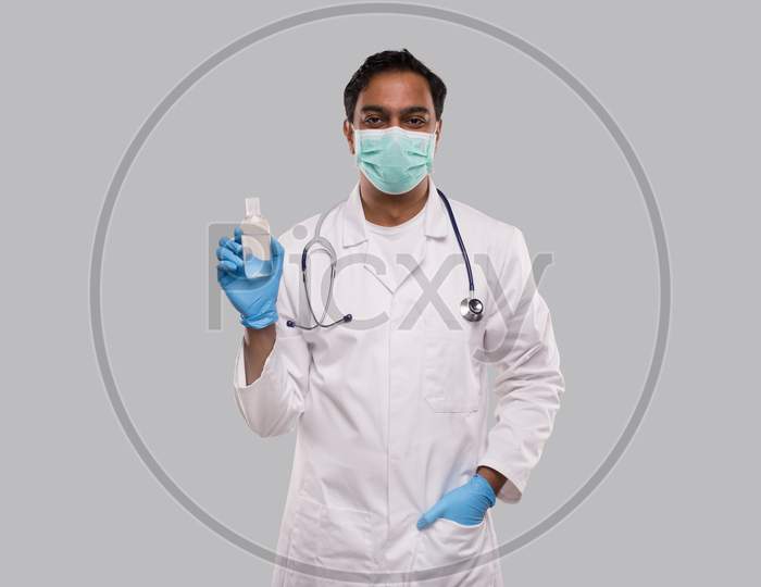 Indian Man Doctor Holding Hands Sanitizer Wearing Medical Mask And Gloves. Hands Wash Antiseptic. Corona Virus Concept. Isolated