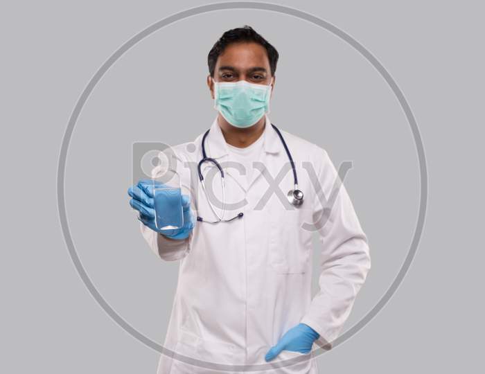 Indian Man Doctor Showing Hands Sanitizer Wearing Medical Mask And Gloves. Hands Wash Antiseptic. Corona Virus Concept. Isolated