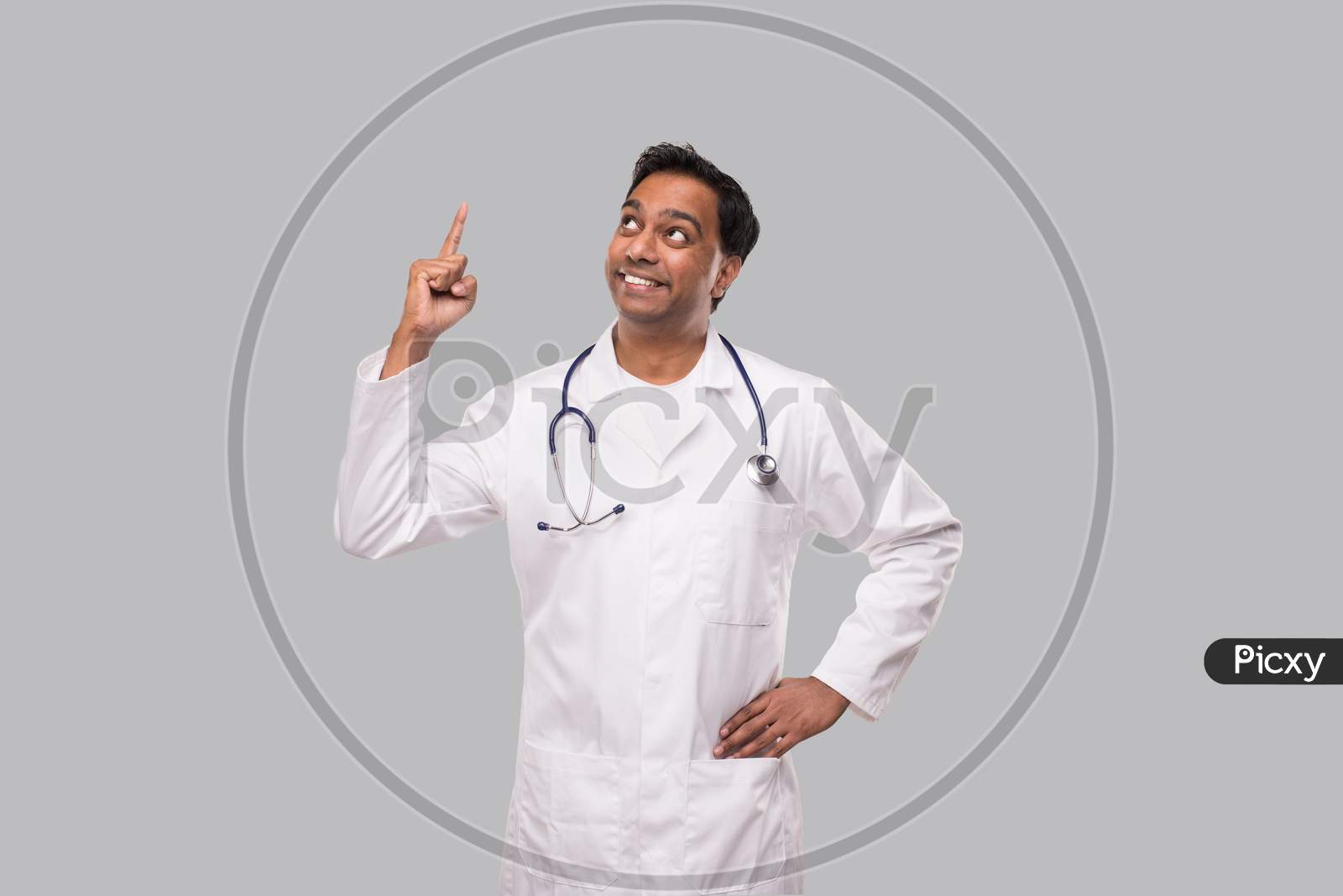 Indian Man Doctor Pointing Up And Watching Up. Isolated