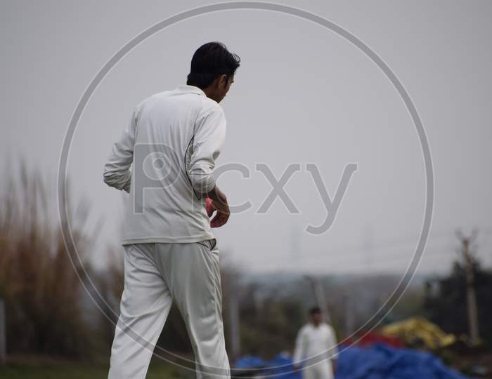 Full length of cricketer playing on field during sunny day, Cricketer on the field in action, Players playing cricket match at field