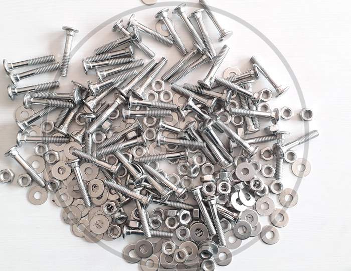 Pile Of Shiny Steel Bolts In White Backgrounds