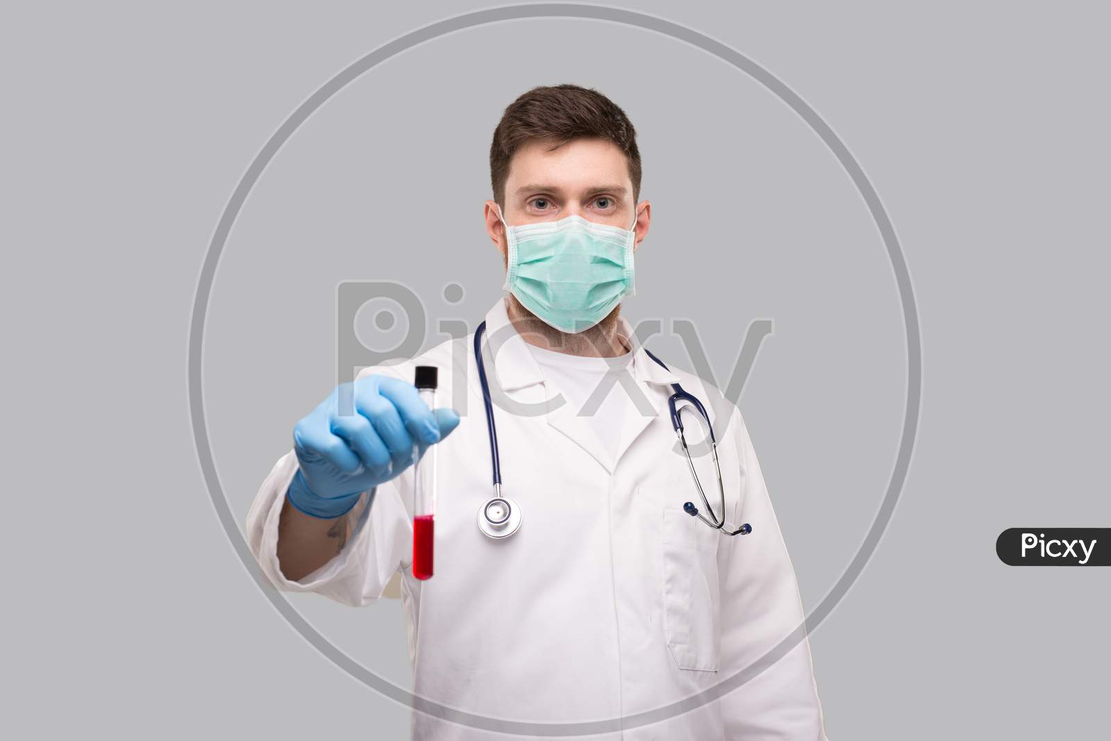 Male Doctor Showing Blood Analysis Wearing Medical Mask And Gloves. Laboratory Virus Concept