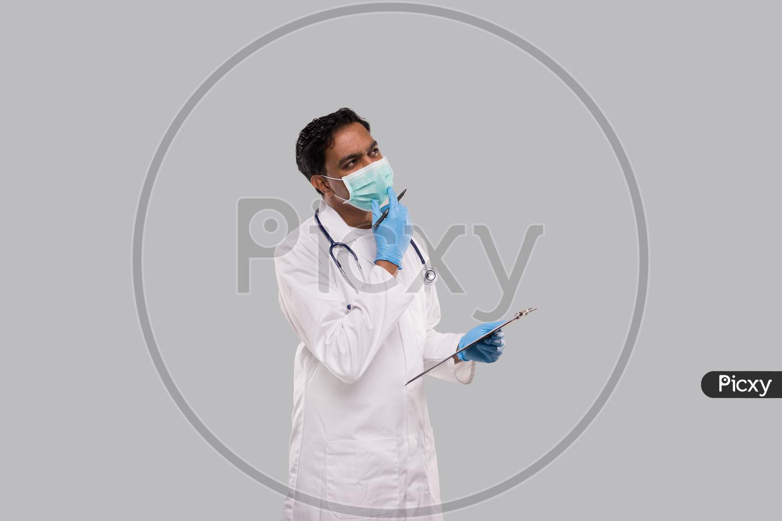 Doctor Thinking With Clipboard Wearing Medical Mask And Gloves. Indian Man Doctor Clipboard Isolated