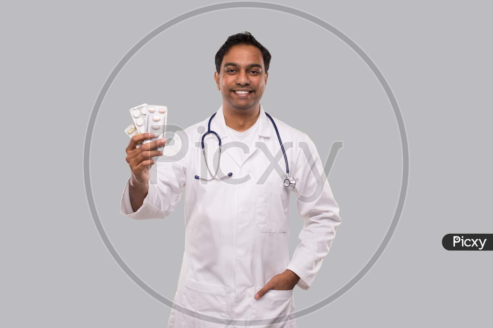 Man Doctor Showing Pills. Doctor Holding Tablets. Indian Man Doctor Isolated.