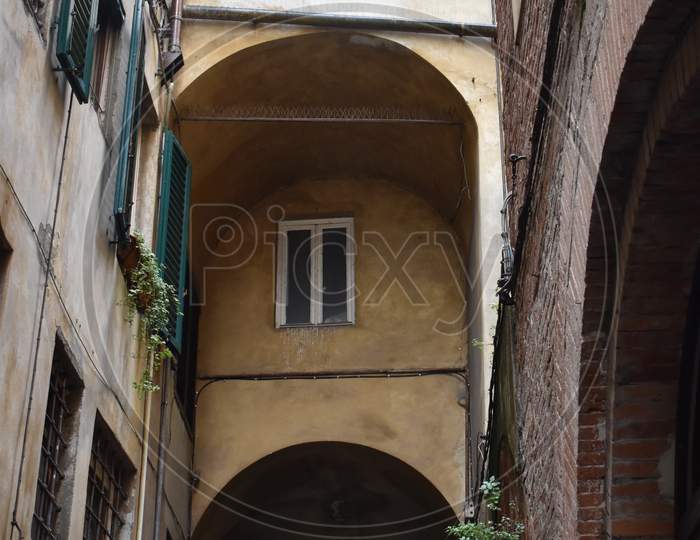 The atmospheric narrow street with the historical buildings in Florence Italy