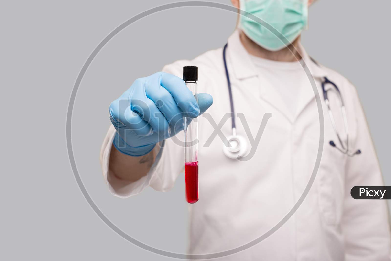 Doctor Showing Blood Analysis Wearing Gloves And Medical Mask. Blood Analysis Close Up. Focus On Blood Test Tube