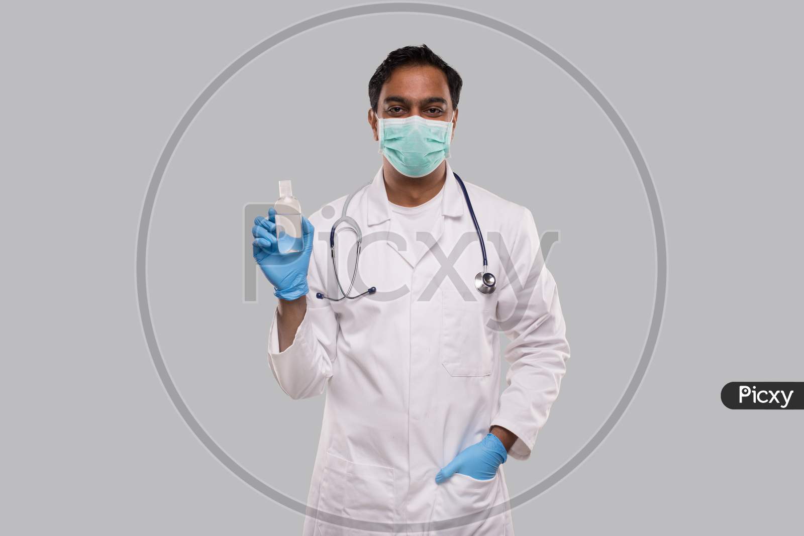 Indian Man Doctor Holding Hands Sanitizer Wearing Medical Mask And Gloves. Hands Wash Antiseptic. Corona Virus Concept. Isolated