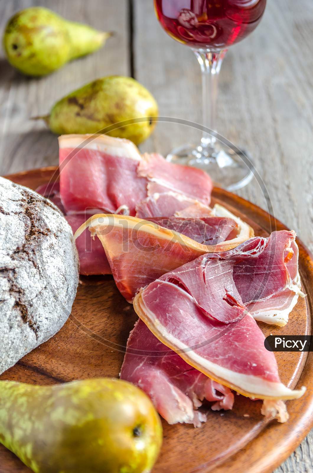 Slices of italian ham on the wooden board