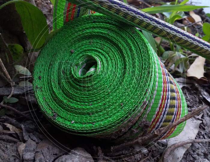 A bundle of rope lying on the ground.