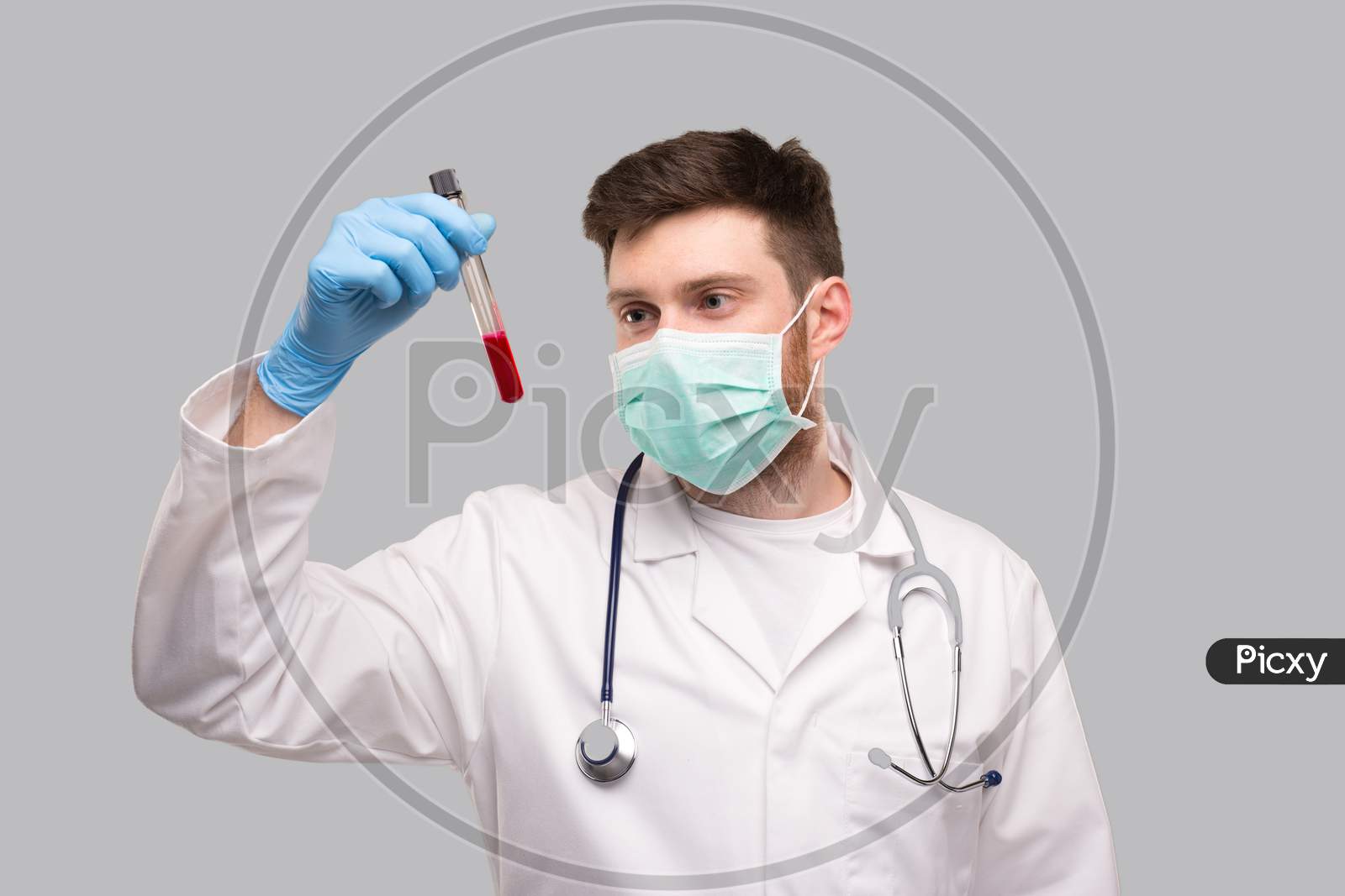 Male Doctor Checking Intently Blood Analysis Wearing Medical Mask And Gloves. Portrait. Virus Analysis Concept