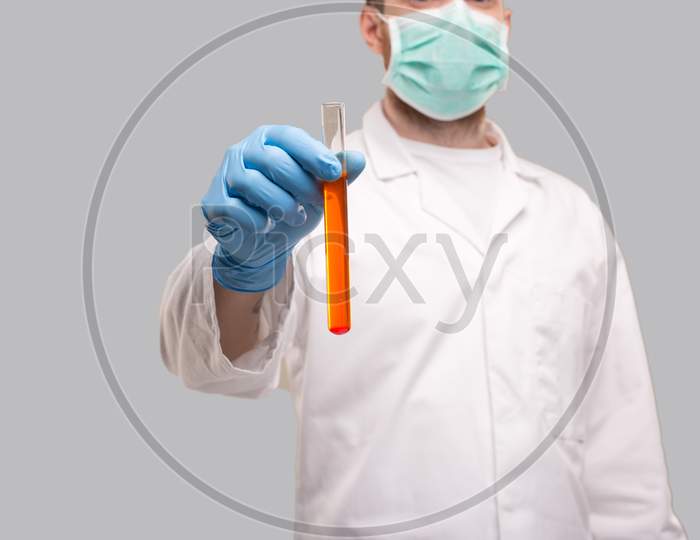 Doctor Showing Blood Analysis Wearing Gloves And Medical Mask. Blood Analysis Close Up. Red Liquid