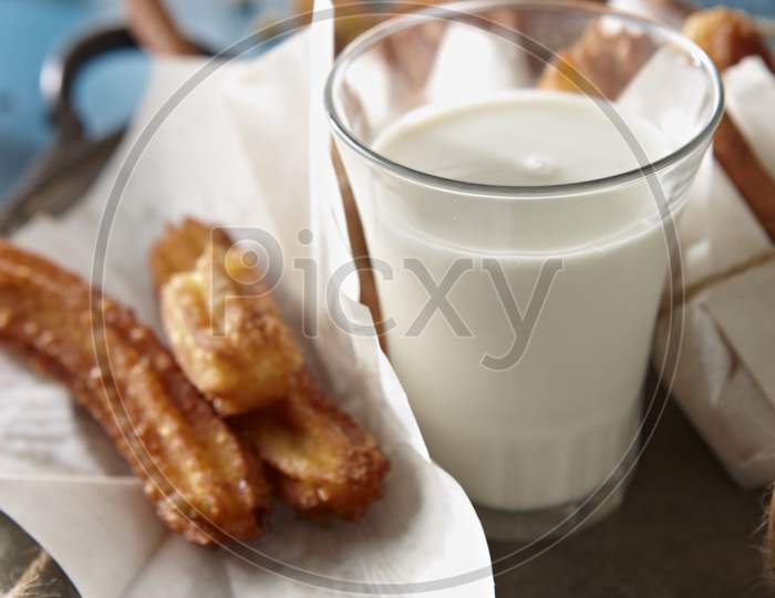 Homemade churros with a glass of milk