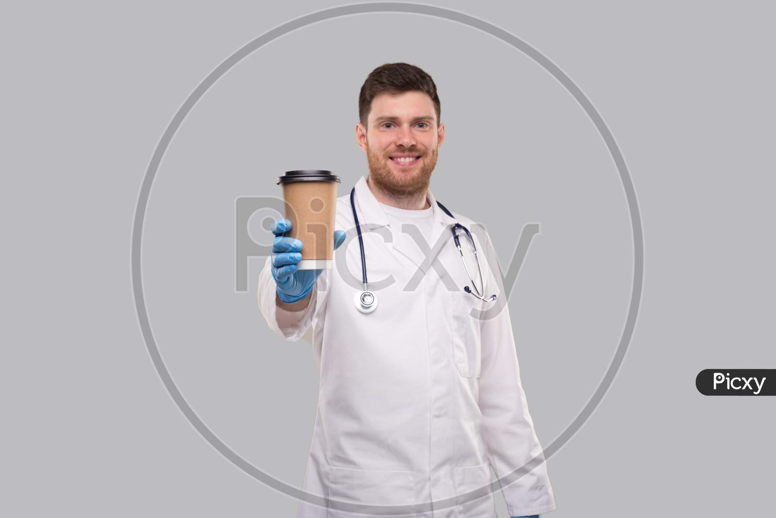 Doctor Showing Coffe To Go Cup Wearing Gloves And Smiling Isolated