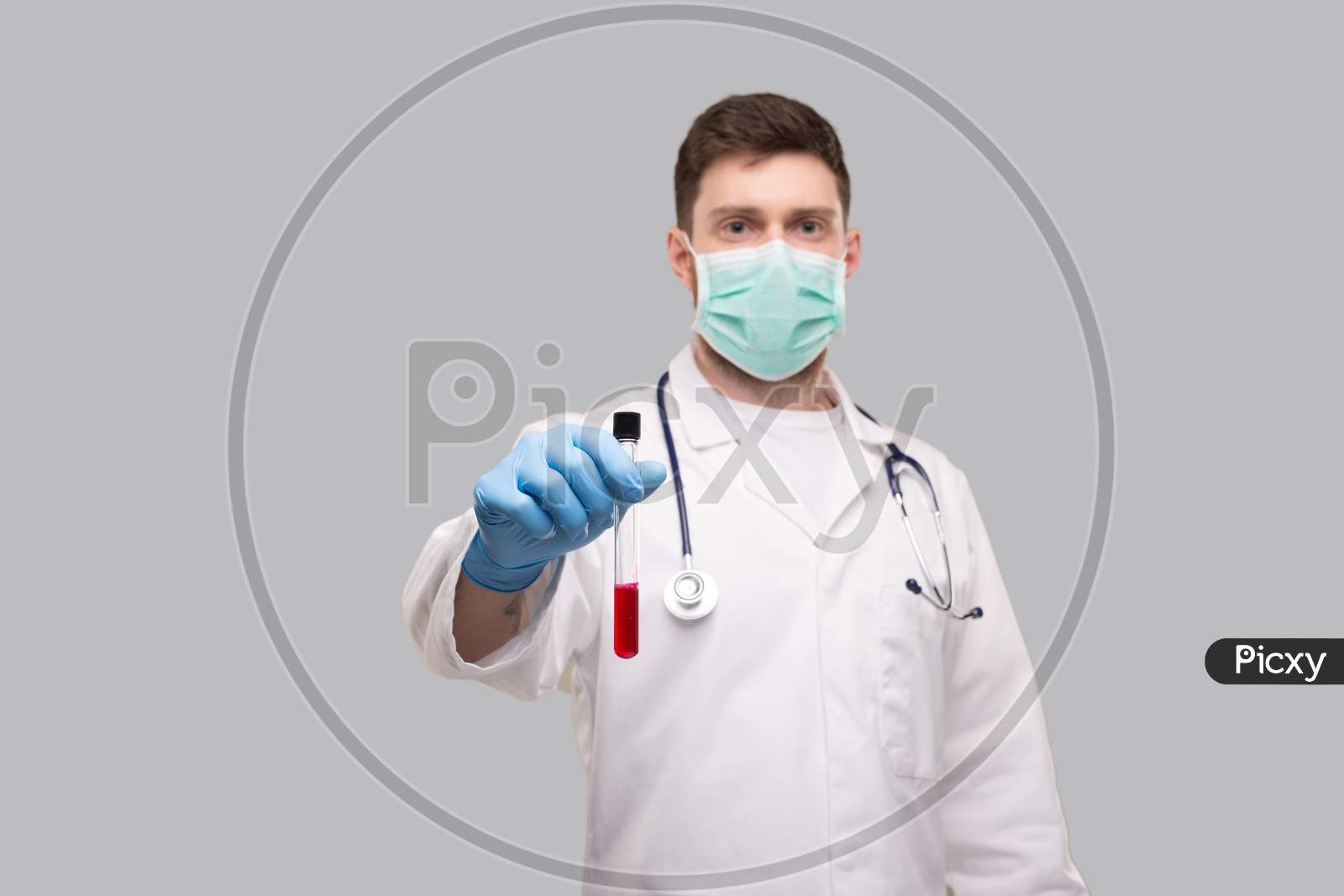 Male Doctor Showing Blood Analysis Wearing Medical Mask And Gloves. Laboratory Virus Concept