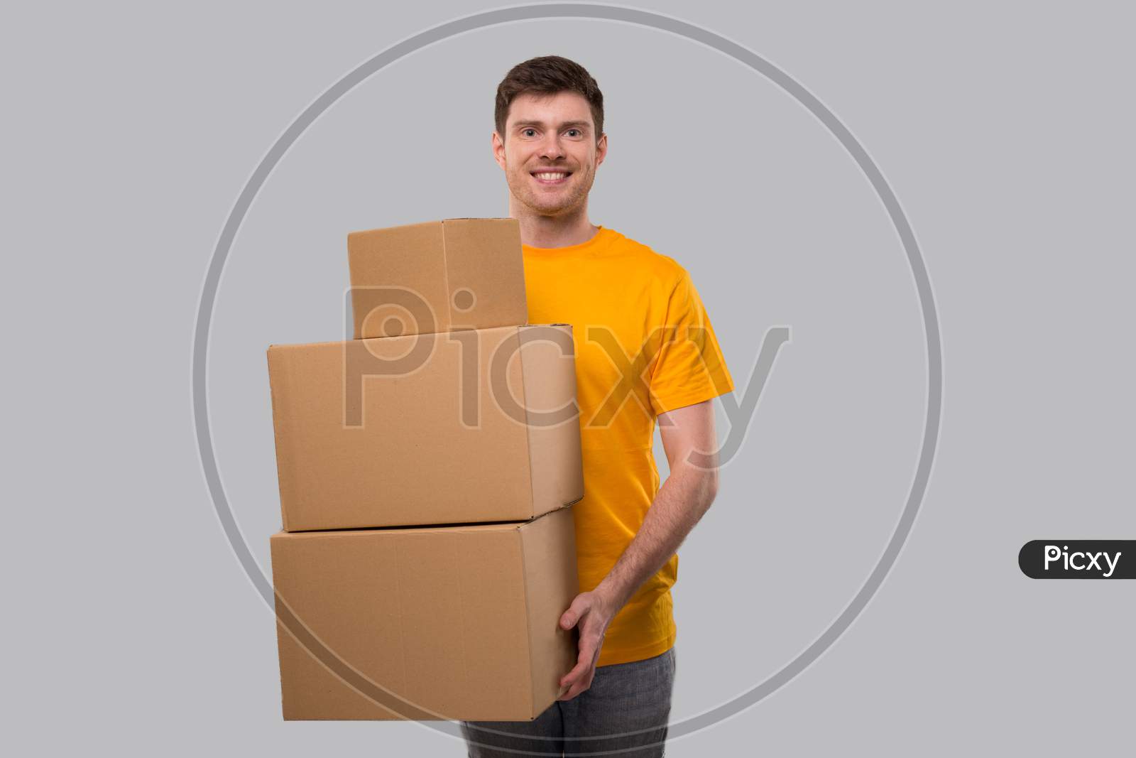 Delivery Man Holding Carton Boxes. Delivery Boy Smiling With Boxes In Hands