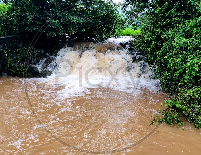 A Muddy Flooded River Water Stream During Monsoon Season