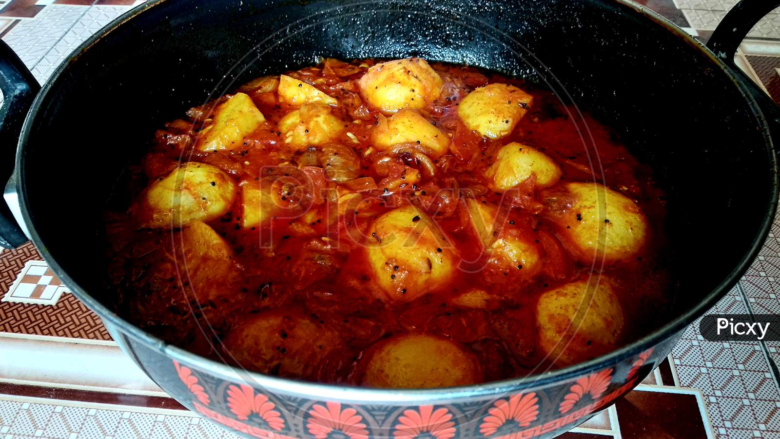 Dum Aloo or Aloo dum, popular Indian dish. Spices and flavoured with chilli, garlic and fennel in smooth gravy which coat the fried potatoes.