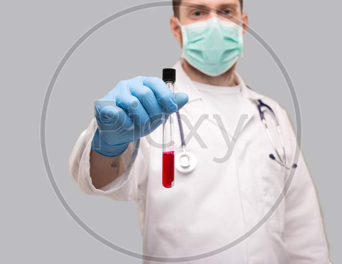 Doctor Showing Blood Analysis Wearing Gloves And Medical Mask. Blood Analysis Close Up.