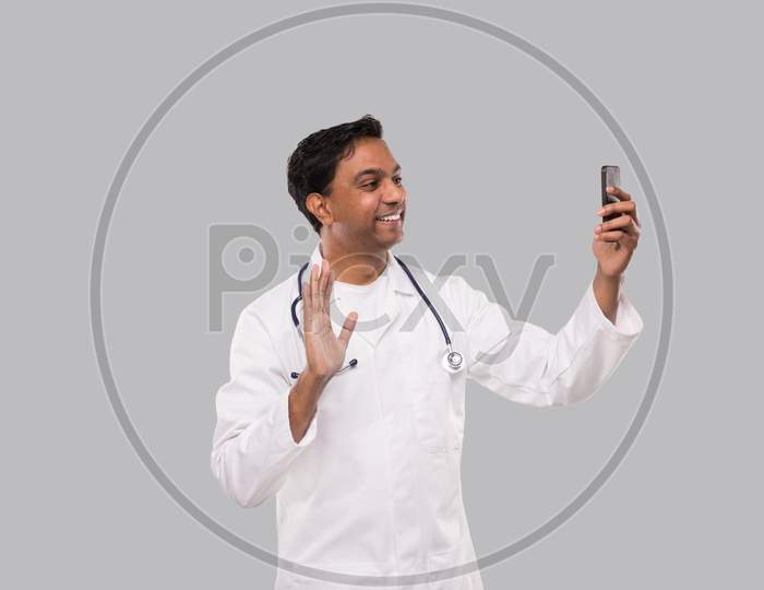 Doctor Having Video Call On Phone Isolated. Indian Man Doctor Video Call. Medicine Online. Doctor Using Phone.